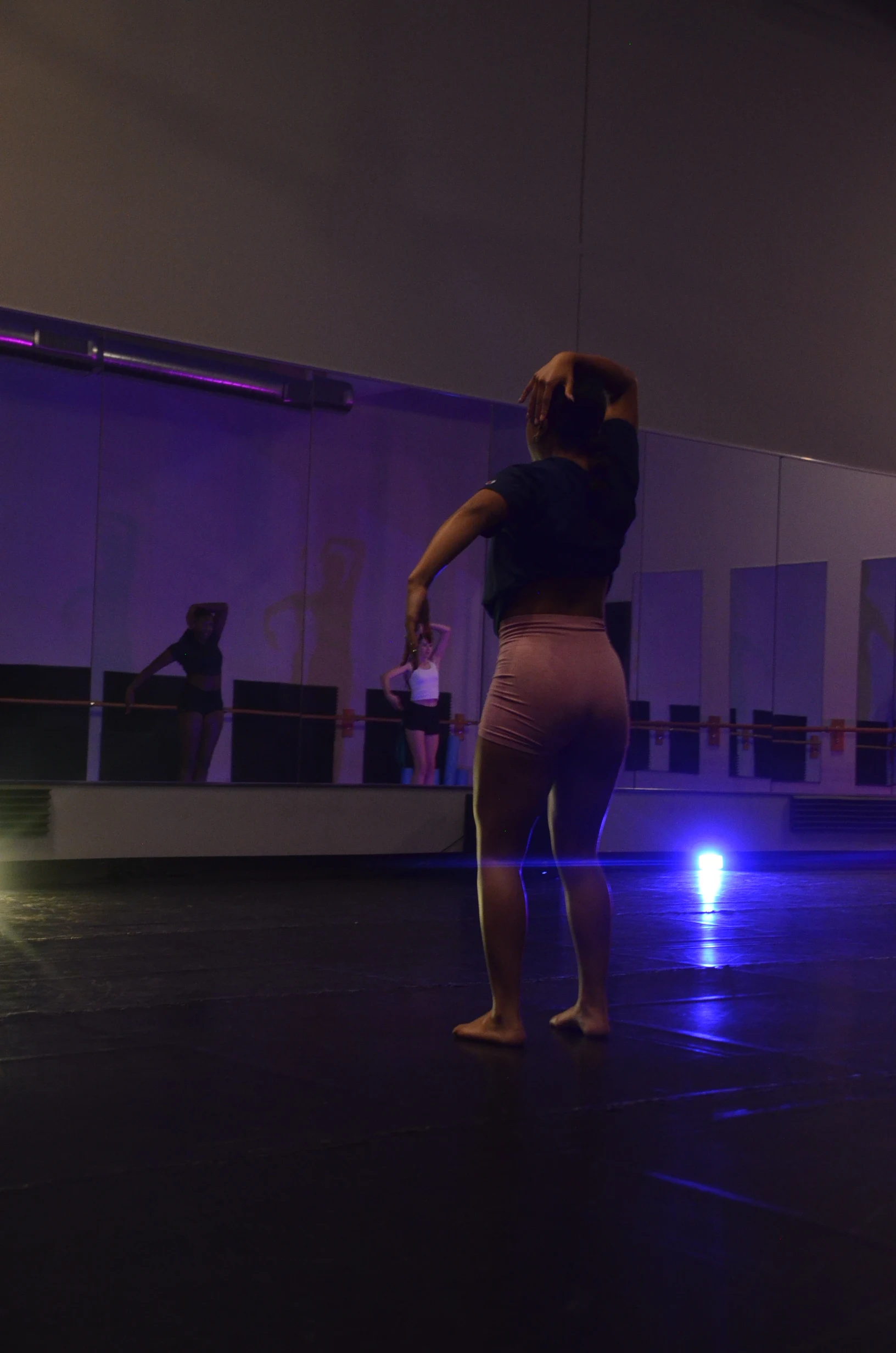 Dancer on a dark studio floor