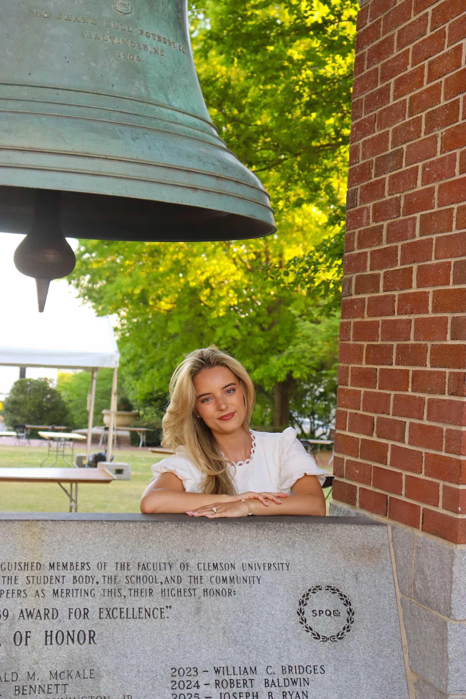 Graduate with campus bell